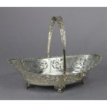A George V silver oval cake basket with gadrooned rim, pierced flower-scroll decoration to the