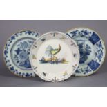 Two 18th century Dutch monochrome delft plates with oriental style painted floral decoration, 8¾”