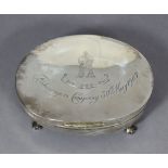 An Edwardian silver oval trinket box, the concave hinged lid engraved with the crest of the