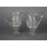 A pair of early 19th century cut-glass ewers with serrated rims, stepped shoulders above the