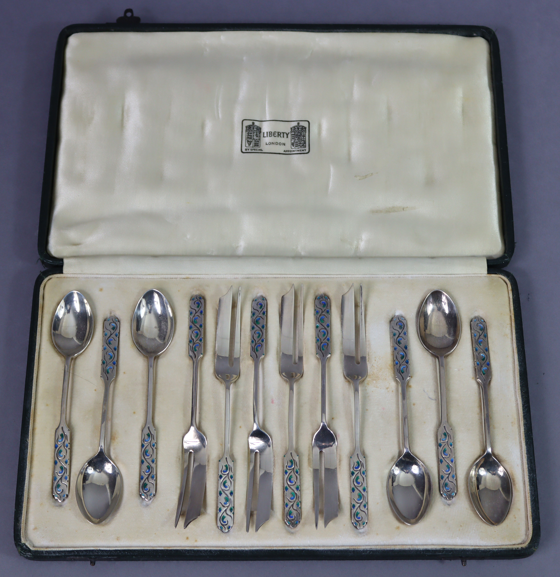 A set of six Liberty & Co. Silver & enamel coffee spoons & six matching cake forks, the elongated