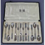 A set of six Liberty & Co. Silver & enamel coffee spoons & six matching cake forks, the elongated