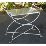 A white painted wrought iron garden table, inset plate glass rectangular top, on curved X-shaped