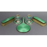 A pair of George V silver dwarf candlesticks on wide round bases, with pale green guilloche enamel