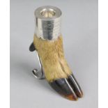 A deer’s foot mounted as a silver match holder, with striker to the rear, supported by two scroll