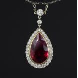 A RED TOURMALINE & DIAMOND PENDANT, the pear-shaped stone weighing approx. 10 carats, set within a