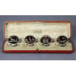 A set of four George V silver dining table place markers, each with oval tortoiseshell panel