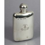 A Victorian silver pocket spirit flask with ball-shaped screw cap, engraved family crest, 5.5” high;