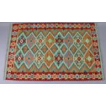 A Choli kilim rug, with repeating multicoloured geometric design within a narrow border, 38.5”