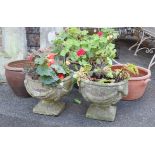 A pair of stone garden urns with swag decoration, 15” wide x 13” high; together with three other