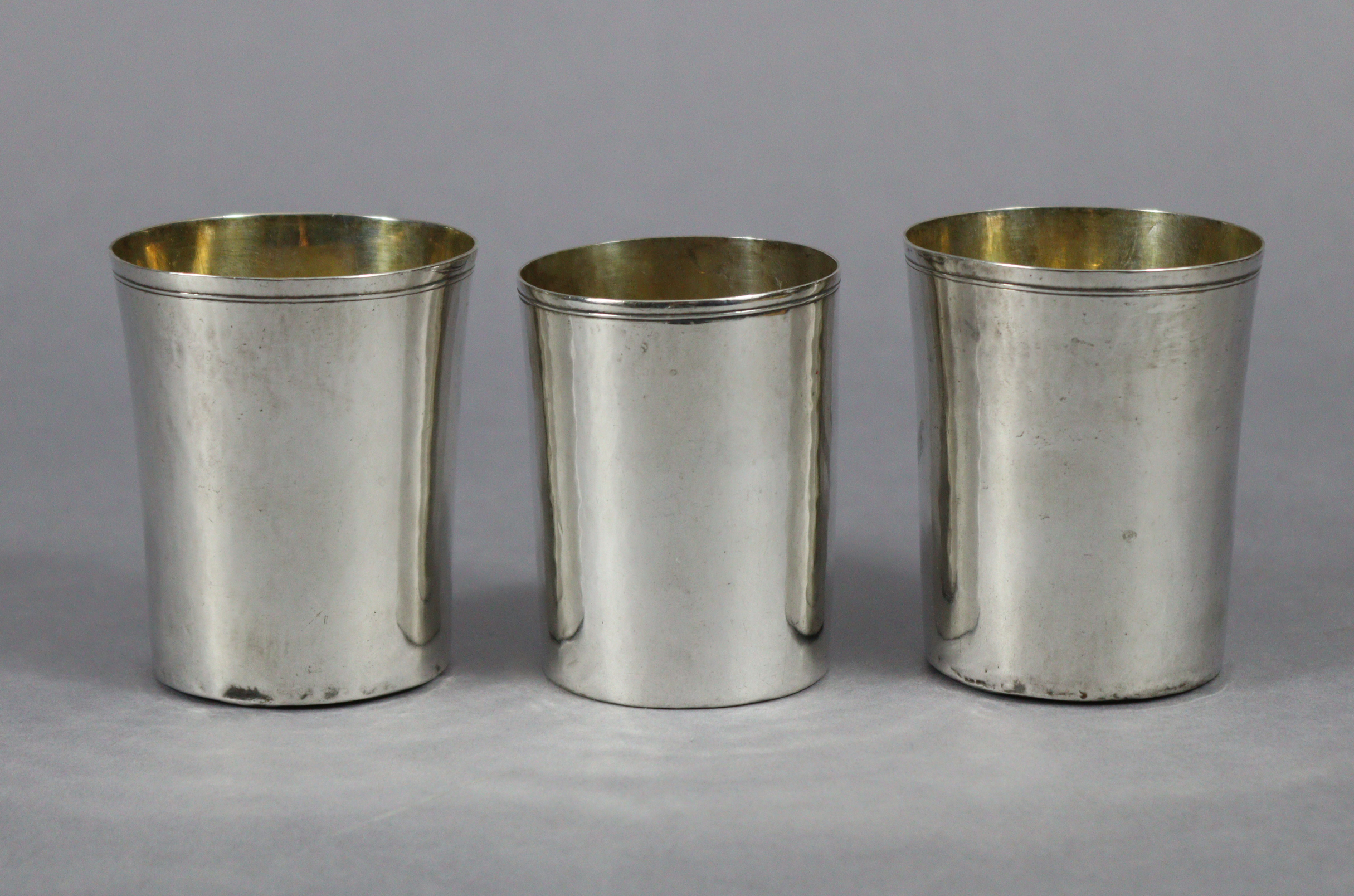 A pair of continental plain beakers with gilt interiors, 3” high x 2.5” diam., & a slightly