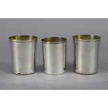 A pair of continental plain beakers with gilt interiors, 3” high x 2.5” diam., & a slightly