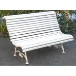 A 19th century-style cast iron garden bench, with slatted wooden seat & back, on tubular scroll