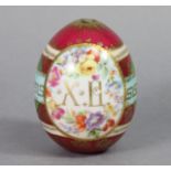 A RUSSIAN IMPERIAL PORCELAIN EASTER EGG of claret ground, with painted flowers & gilt decoration;
