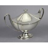 A George III style silver two-handled soup tureen of fluted oval shape, with urn finial to the