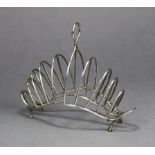 A Victorian silver ‘hump-back’ toast rack of eight arched wire divisions, with centre ring handle, &