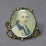 A late 18th century portrait miniature of a gentleman wearing white coat with blue collar & white