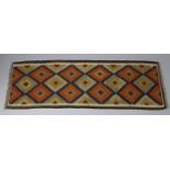 A Maimana kilim runner of ochre ground with repeating geometric lozenge design within a narrow