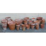 A large quantity of assorted terracotta garden plant pots (approx. 50 in total).