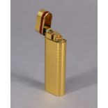 A Cartier of Paris gold plated cigarette lighter (No. 33551N).