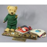 A golden plush teddy bear, 16.5” tall (worn); a Russian soldier’s cap with numerous badges; a