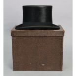 A Harrods of London black silk top hat, inside measurements 8” x 6¼”, with “Chapmans’” patent case.