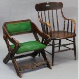 A carved oak elbow chair with padded seat & back upholstered green material, & on x-shaped end