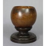 A 19th century coconut cup, 3½” high, on lignum vitae circular base, 5¾” high x 4¾” diam. over-all.