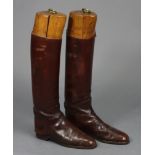 A pair of vintage tan leather riding boots (size 7.5), with treen trees.