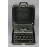 A vintage “Royal” typewriter in fibre-covered travelling case, 13” wide x 16.5” high.