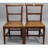 A pair of cottage rail-back dining chairs, with hard seats & on square tapered legs with plain