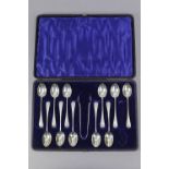 A part set of eleven silver engraved teaspoons & a matching pair of sugar tongs, Chester 1900,