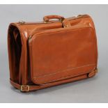A BALLY BROWN LEATHER FOLD-OVER SUITCASE with a central hanging compartment fitted two brass hangers