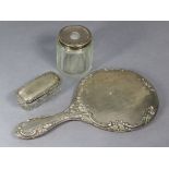A George V silver-backed hand mirror with embossed foliate design Birmingham 1916; & two glass