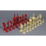A SET OF VINTAGE CARVED IVORY CHESSMEN of red & natural stained (size of kings 5¾” high), slight