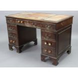 A reproduction mahogany small pedestal desk inset gilt-tooled tan leather, & fitted with an