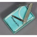 A Latama (Italian) stainless steel pocket knife; & a Tiffany & Co. small cardboard box, 3¼” wide.