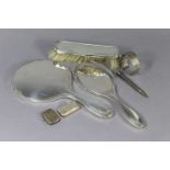 A silver ingot, 98.5g; together with three silver-mounted dressing table items; a silver vesta case,