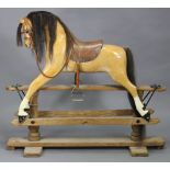 A VINTAGE STEVENSON BROTHERS(?) PALOMINO PAINTED WOODEN ROCKING HORSE on pine trestle base with