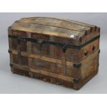 A steal-bound wooden ribbed domed-top trunk with a hinged lift-lid, 32” wide x 21” high.