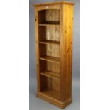 A pine tall standing five-tier open bookcase 26” wide x 66” high x 10” deep.