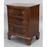 A mahogany bow-front three-drawer bedside chest on bracket feet, 19¼” wide x 26” high x 15¼” deep.