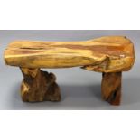 A rustic hardwood coffee table with a shaped top, & on a pair of end supports, 44” x 18½”;