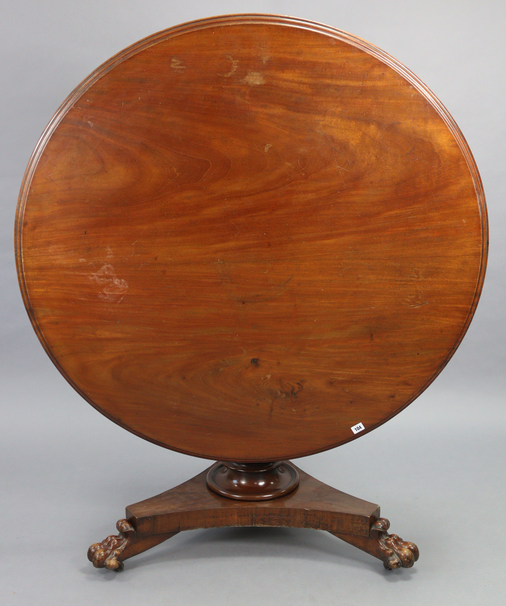 . A 19th century mahogany “loo” table or dining table with a circular tilt-top, & on an octagonal