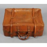 A Fortnum & Mason brown leather suitcase with fitted interior, twin carry handles & leather