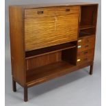 A mid-20th century teak side cabinet, fitted with an arrangement of open shelves, drawers &