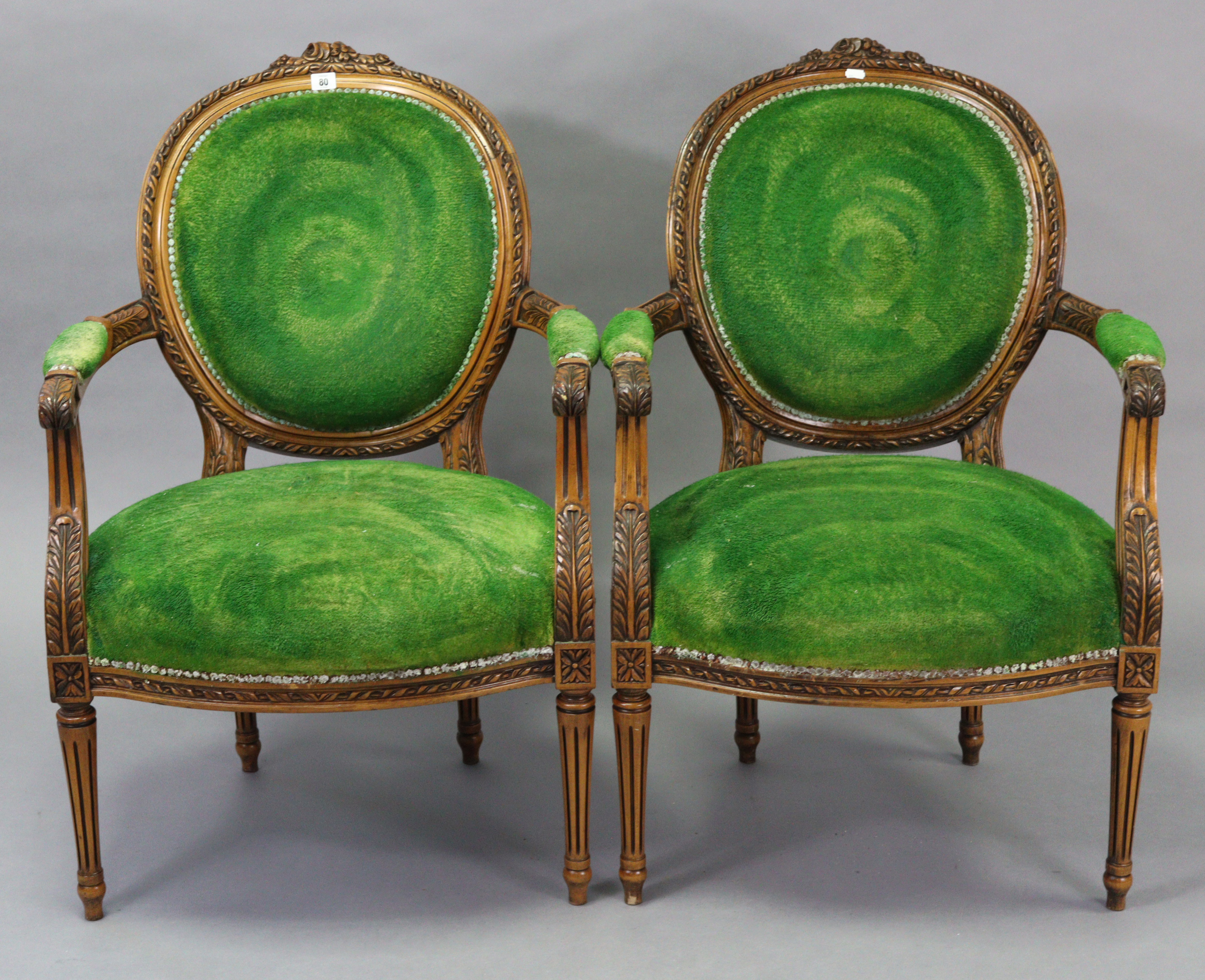 A pair of Louis XVI-style carved beech frame armchairs with padded seats & backs upholstered green