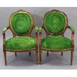 A pair of Louis XVI-style carved beech frame armchairs with padded seats & backs upholstered green