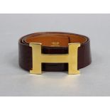 HERMES, Paris; A brown crocodile leather belt with gilt metal ‘H’ buckle, 42” long (including