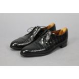 CODNER, COOMBS & DOBBIE Ltd., A pair of crocodile leather black lace-up men’s shoes (size between